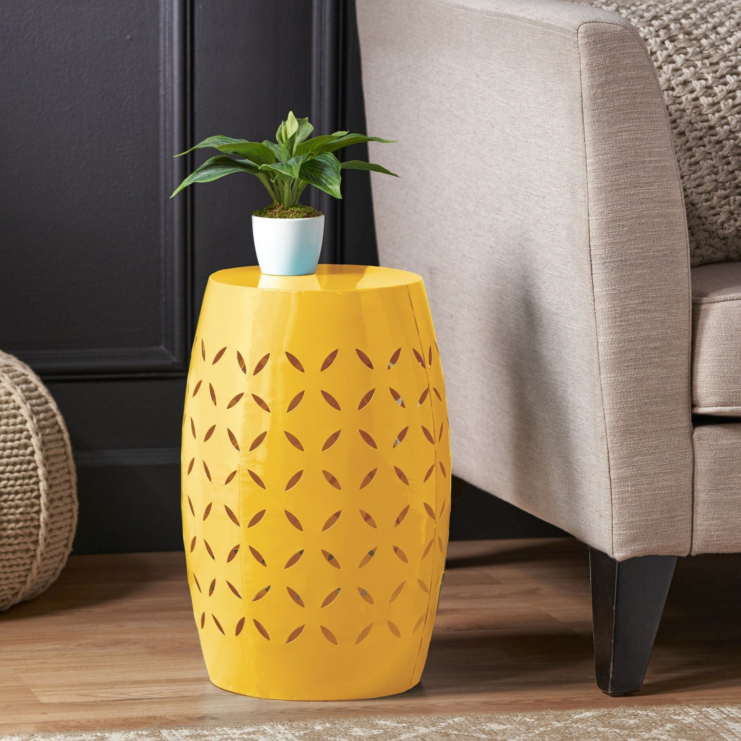 Barrel-shaped outdoor side table in yellow metal with leaf-cutout pattern on Tampa Home & Garden Store