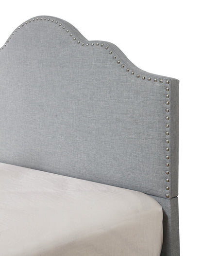 Kopa fabric upholstered bed headboard in grey linen with curved top and silver nailhead trim on Tampa Home & Garden Store