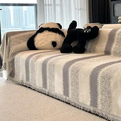 Beige-gray striped sofa slipcover with two plush toys panda and black plush on living room sofa on Tampa Home & Garden Store