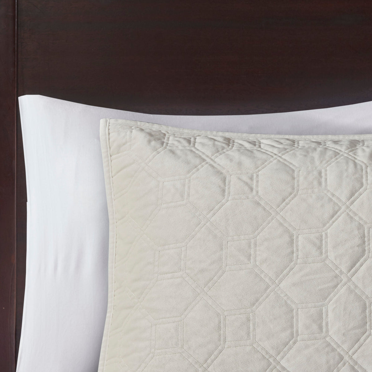 Ivory velvet quilt set with hex quilt pattern on bed on Tampa Home & Garden Store