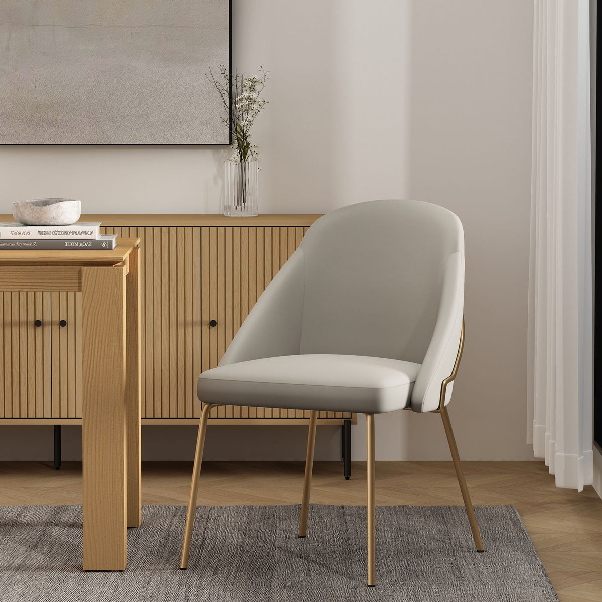 Upholstered dining chair with high-density foam in light gray fabric and slim gold legs on Tampa Home & Garden Store