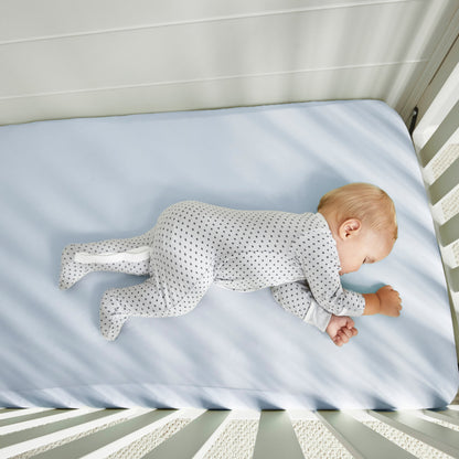 BedGear Dri-Tec baby blue crib sheet on crib mattress with sleeping baby in dotted sleeper on Tampa Home & Garden Store