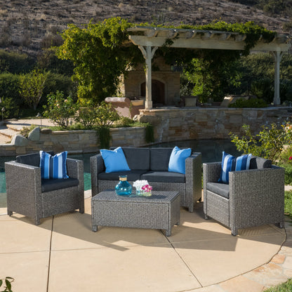 Puerta 4-Piece Outdoor Furniture Set dark gray wicker seating with blue cushions around a coffee table under a vine-draped pergola on Tampa Home & Garden Store