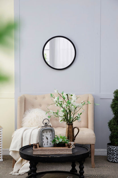 Circle wall mirror with wooden frame on pale blue paneled living room wall on Tampa Home & Garden Store