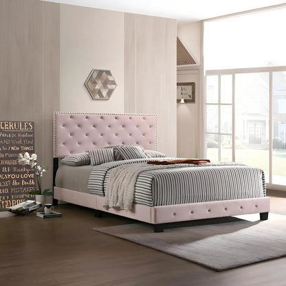 Luxurious upholstered bed with pale pink tufted headboard and striped bedding on Tampa Home & Garden Store