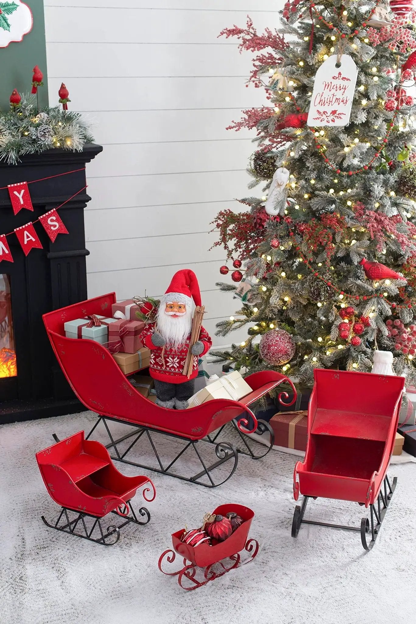 Large distressed red iron Santa sleigh holiday decoration with gifts and Christmas tree on Tampa Home & Garden Store