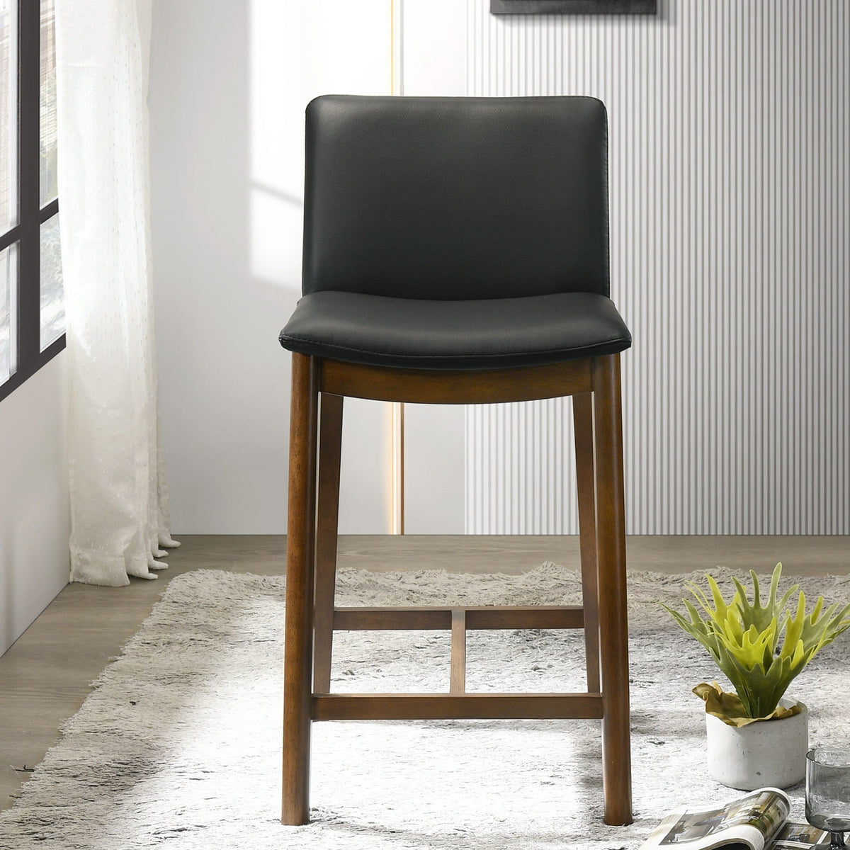 Mid-Century counter chair with full-back, black upholstered seat and wooden legs on Tampa Home & Garden Store