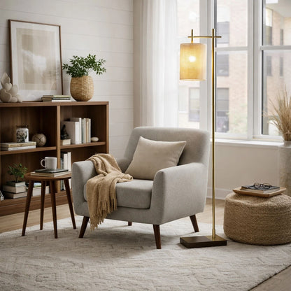 Brizo Tall Corner Floor Lamp Gold with woven shade beside a window in a cozy living room on Tampa Home & Garden Store