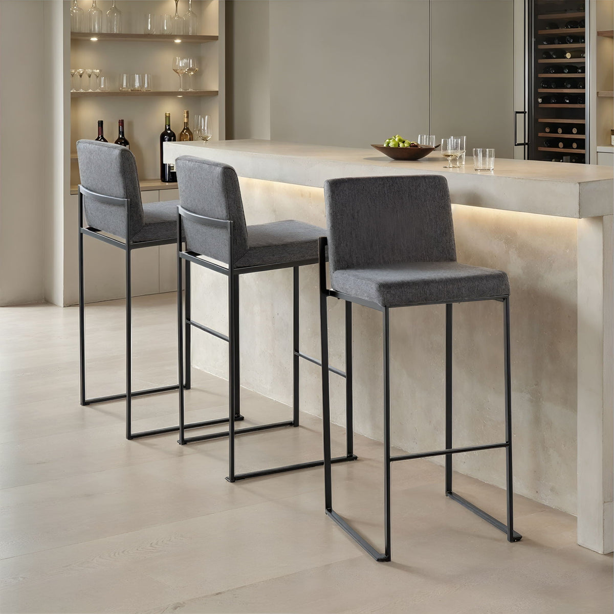 Three high back barstools in gray fabric with black metal frames at a concrete kitchen island on Tampa Home & Garden Store