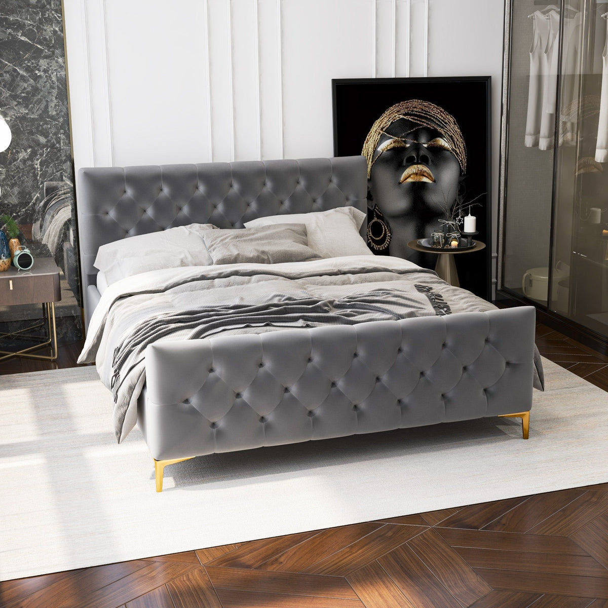 Upholstered bed with dark gray tufted headboard and wood frame with gold legs on Tampa Home & Garden Store