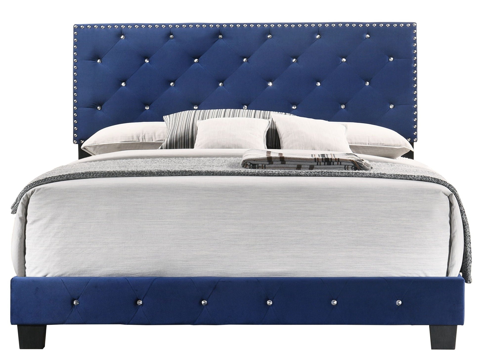 Luxurious blue tufted bed with crystal studs, gray bedding and dark wood legs on Tampa Home & Garden Store