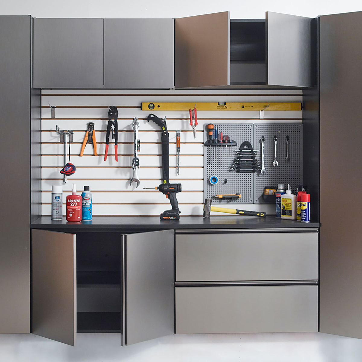 Wall mounted garage cabinet with soft close doors in dark gray above a pegboard tool wall on Tampa Home & Garden Store