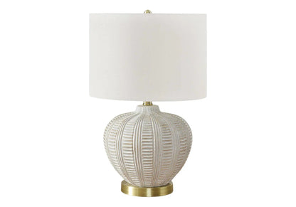 Table lamp with cream resin base featuring ribbed texture and ivory fabric shade on Tampa Home & Garden Store