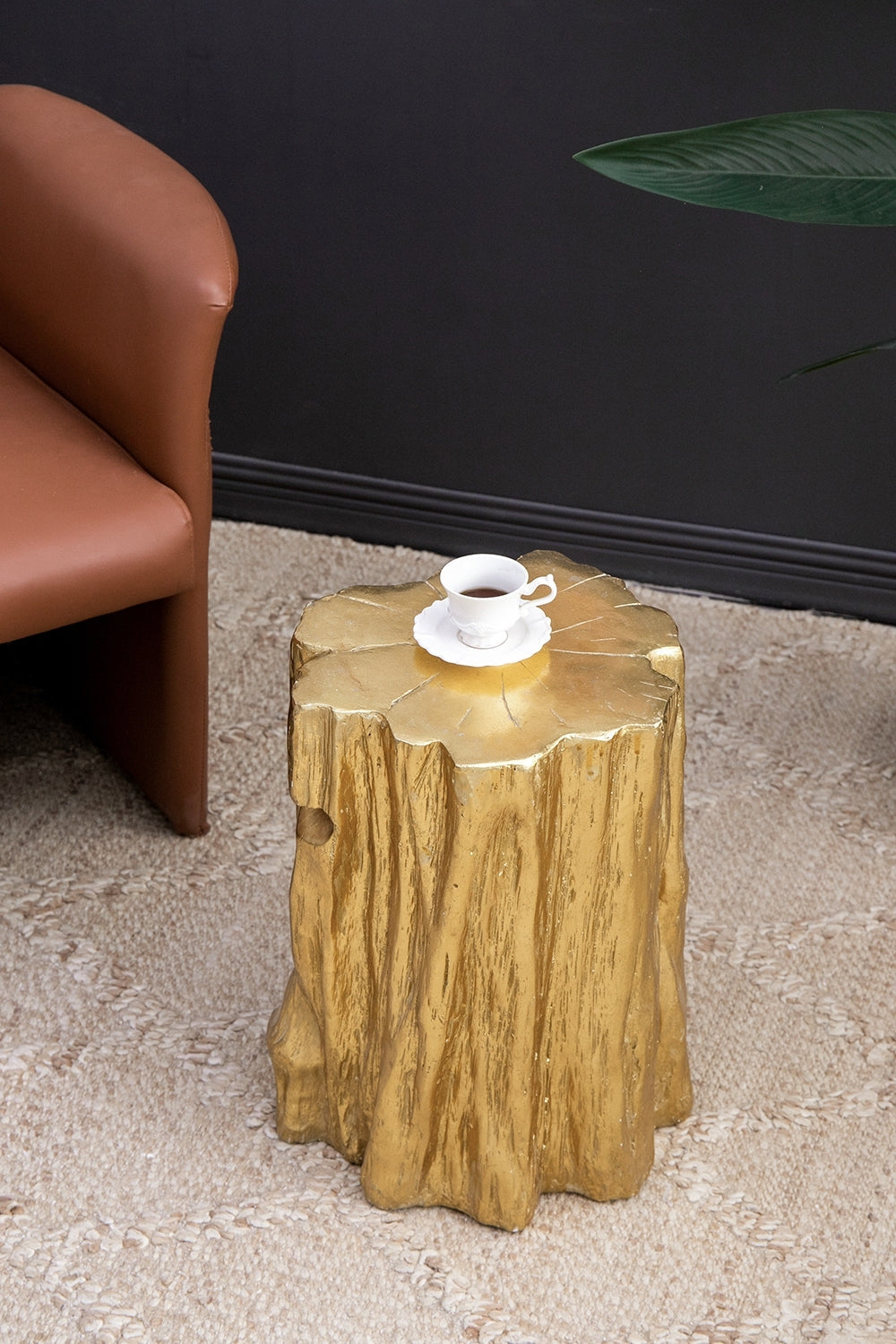 Golden Tree Trunk Stool with antique gold distressed finish by HouseOfZazla used as a side table on Tampa Home & Garden Store