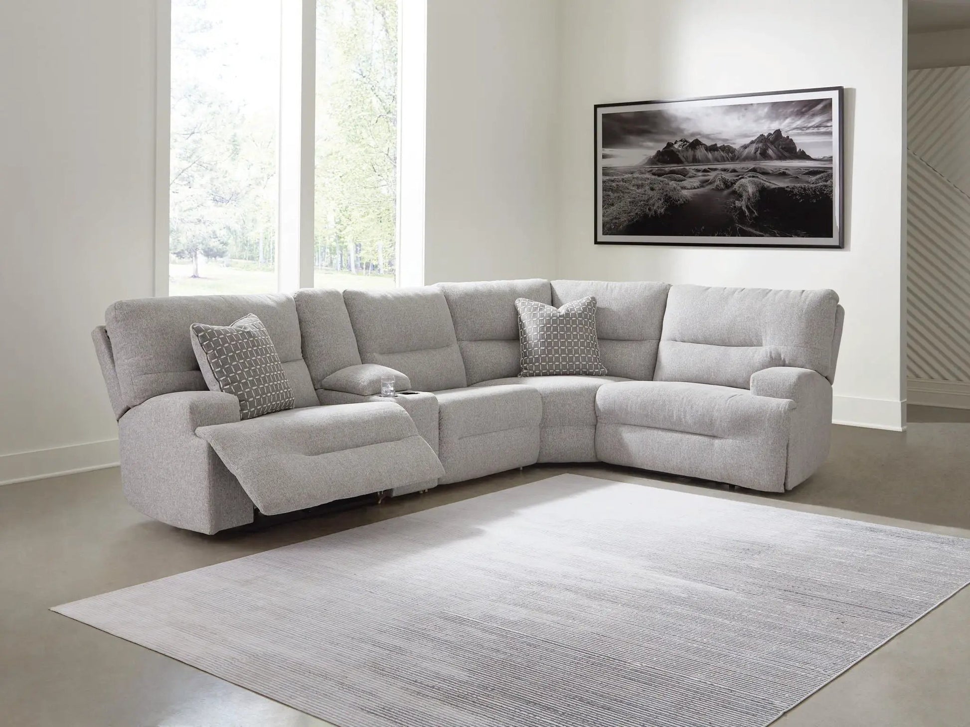 Acklen Place Reclining Sectional in light gray fabric with geometric pillows on Tampa Home & Garden Store
