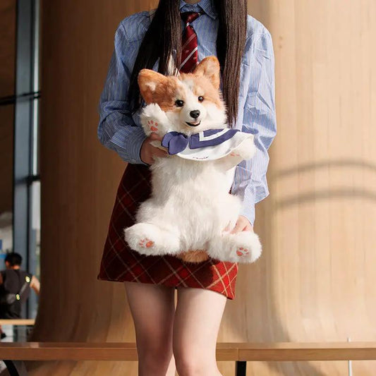 Chongker Corgi Backpack for kids and pet fans, plush corgi toy held by model in shirt on Tampa Home & Garden Store