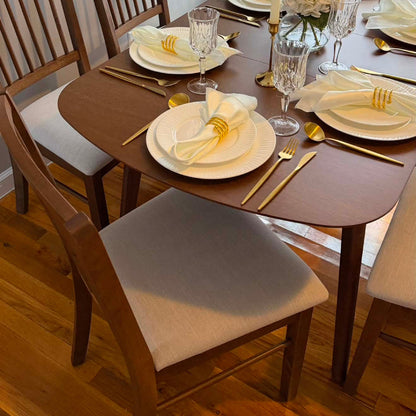Extendable dining table set seating 4–6 in dark wood with beige chairs on Tampa Home & Garden Store