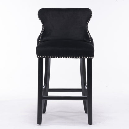 Upholstered wing-back barstool with button tufting and nailhead trim in black velvet, black wood legs on Tampa Home & Garden Store