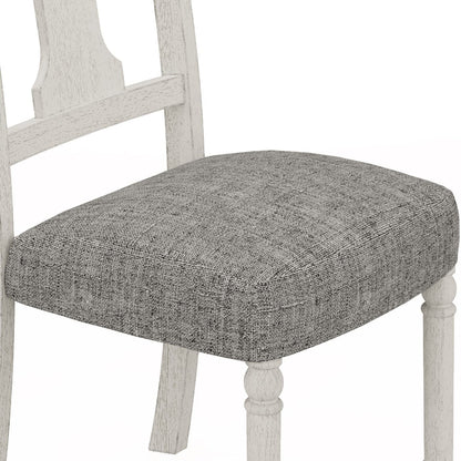 Whitewashed wooden dining chair with gray upholstered seat cushion and turned legs on Tampa Home & Garden Store