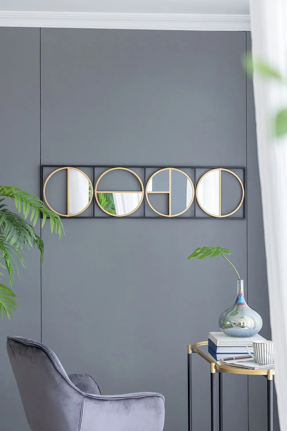 Accent mirrors: eclectic metal beaded wall mirror panel with four gold-ring circles on gray wall on Tampa Home & Garden Store
