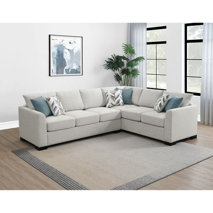 Radison greige upholstered sleeper sectional sofa with teal accent pillows in a living room on Tampa Home & Garden Store