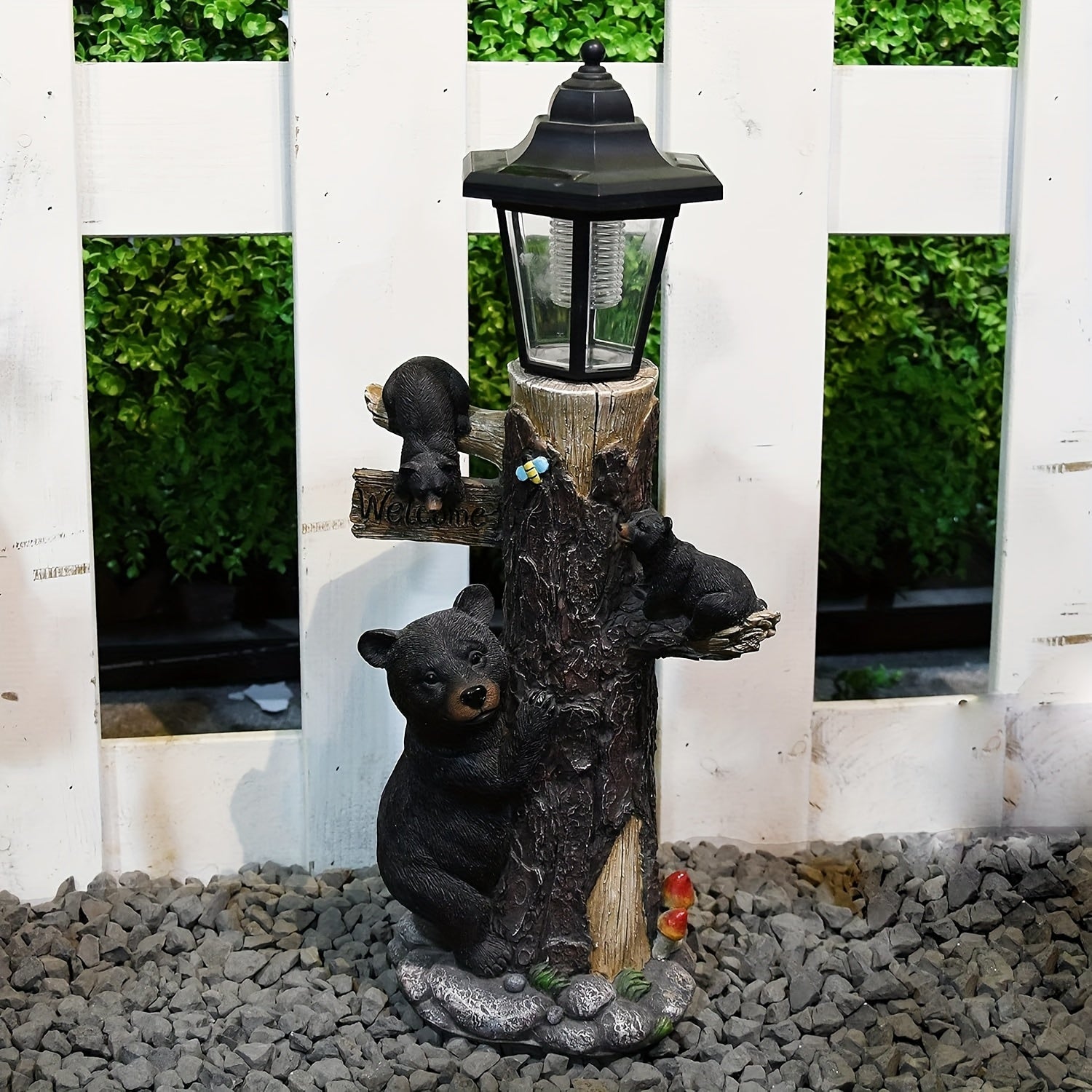 Black bear statue garden sculpture with a welcome sign and solar lantern atop a tree stump on Tampa Home & Garden Store