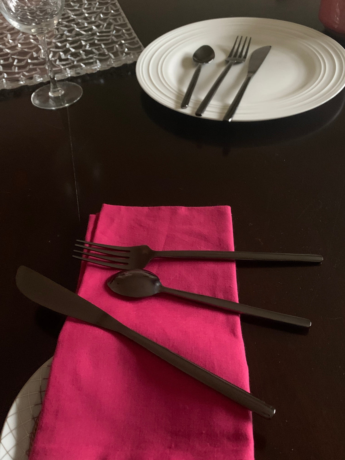 Vibhsa stainless steel flatware 18 pc set with matte black handles on pink napkin on Tampa Home & Garden Store