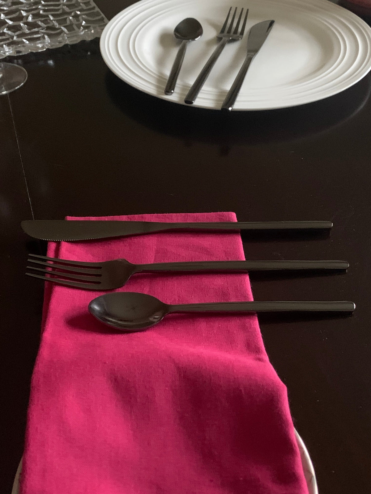 Vibhsa Black Stainless Steel Flatware 36 pc Set with black knife fork spoon on pink napkin on Tampa Home & Garden Store