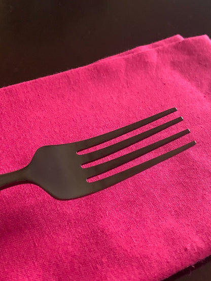 Vibhsa black stainless steel fork from a 36 pc flatware set on bright pink napkin on Tampa Home & Garden Store