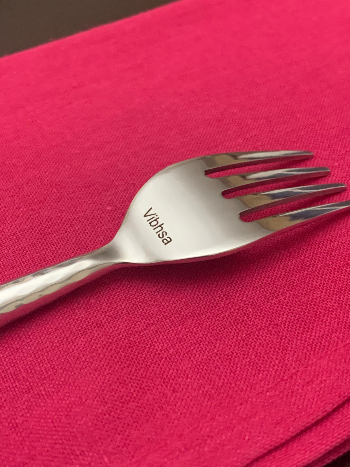 Vibhsa hammered silver stainless steel fork, 20-piece flatware set, on pink fabric on Tampa Home & Garden Store
