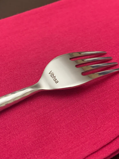 Vibhsa hammered silver stainless steel fork, 20-piece flatware set, on pink fabric on Tampa Home & Garden Store