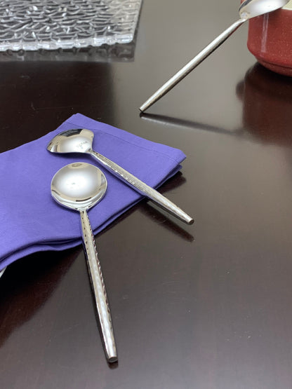 Vibhsa soup spoons 6-piece set in polished stainless steel on purple napkin on Tampa Home & Garden Store