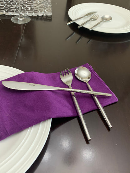 Vibhsa 36-PC silverware set with knife fork spoon on purple napkin beside white plates on Tampa Home & Garden Store