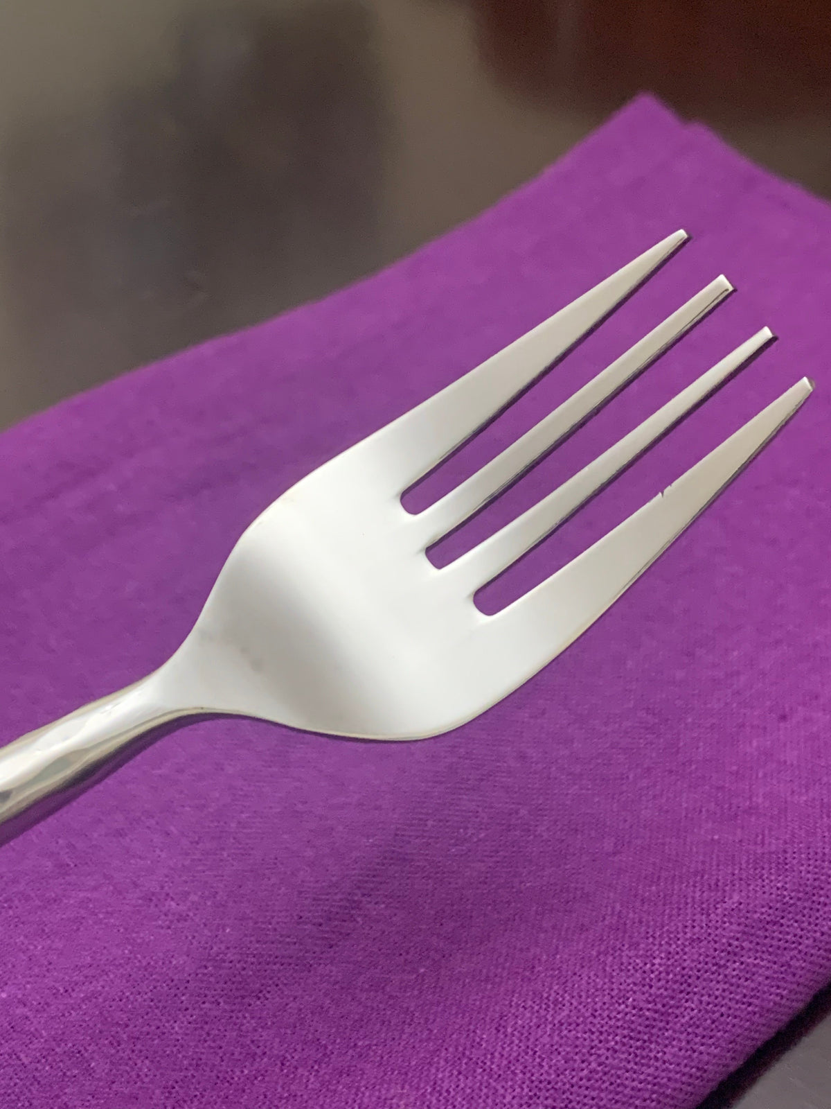 Vibhsa silverware fork close-up on purple fabric on Tampa Home & Garden Store