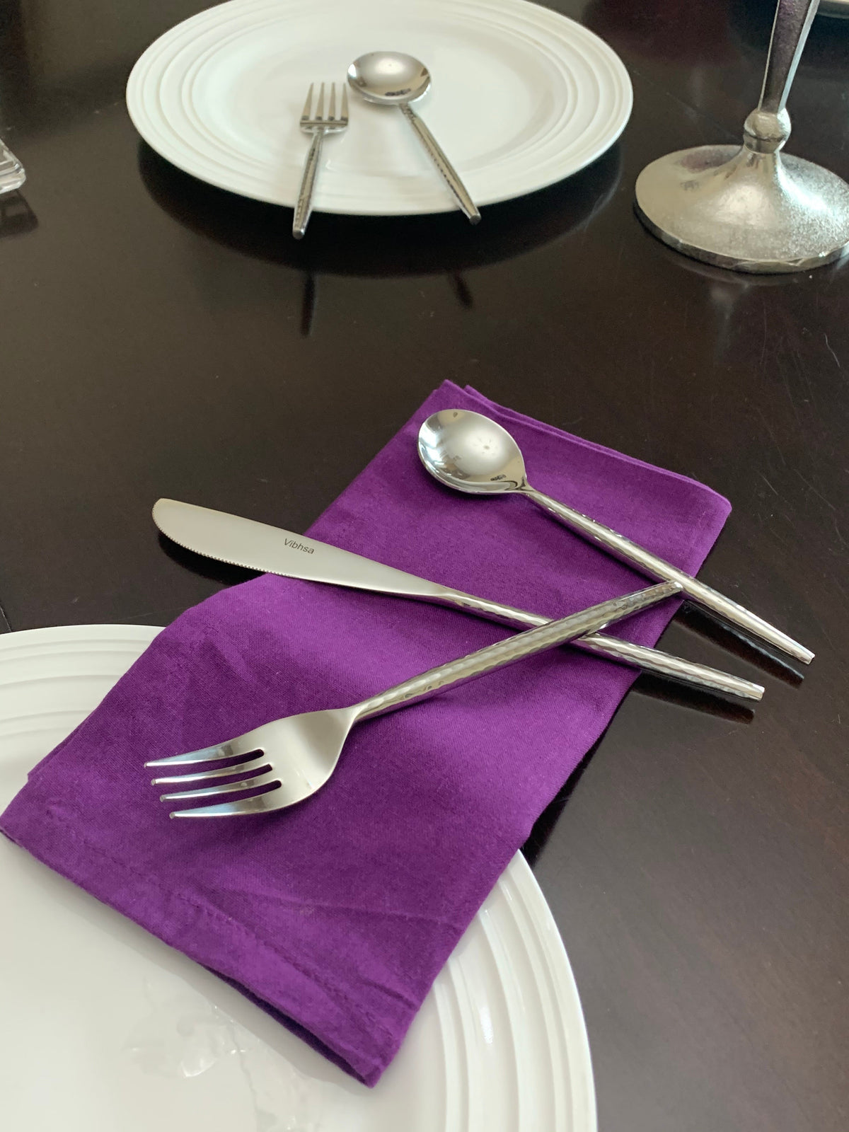Vibhsa hammered stainless steel flatware 18-piece set with fork knife spoon on purple napkin on Tampa Home & Garden Store