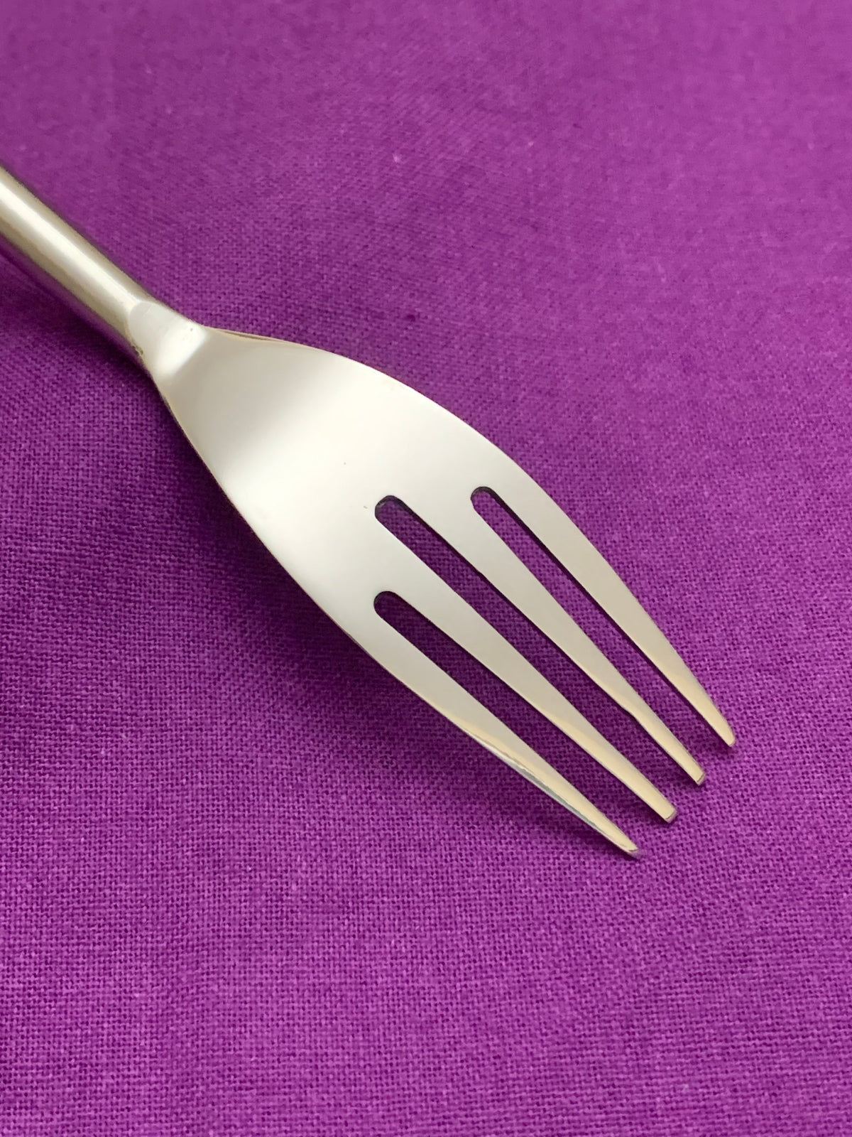 Vibhsa modern stainless steel flatware fork with cream handle on purple fabric on Tampa Home & Garden Store