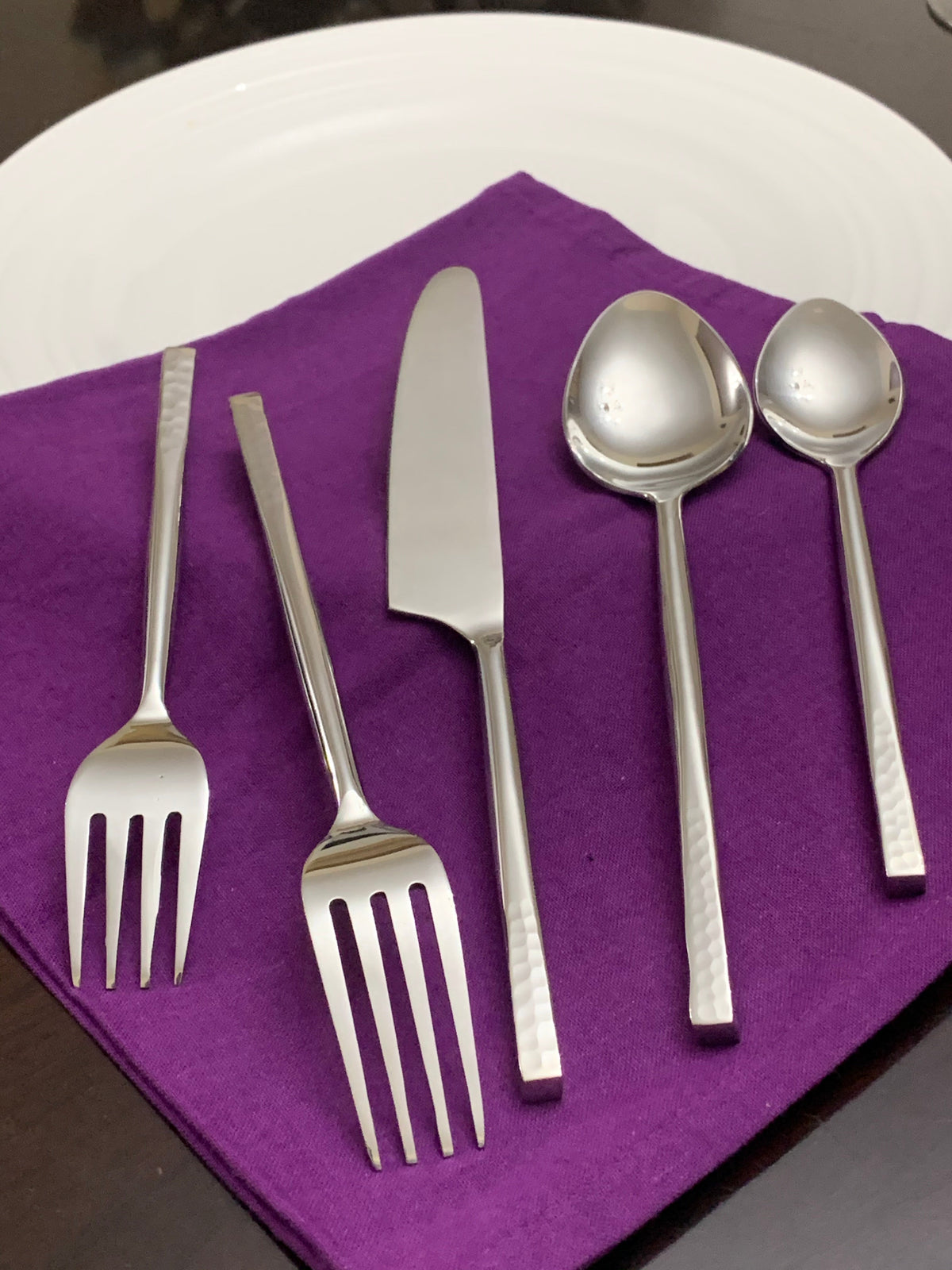 Vibhsa flatware set 20-piece service for 4 in silver with hammered handles on purple napkin on Tampa Home & Garden Store