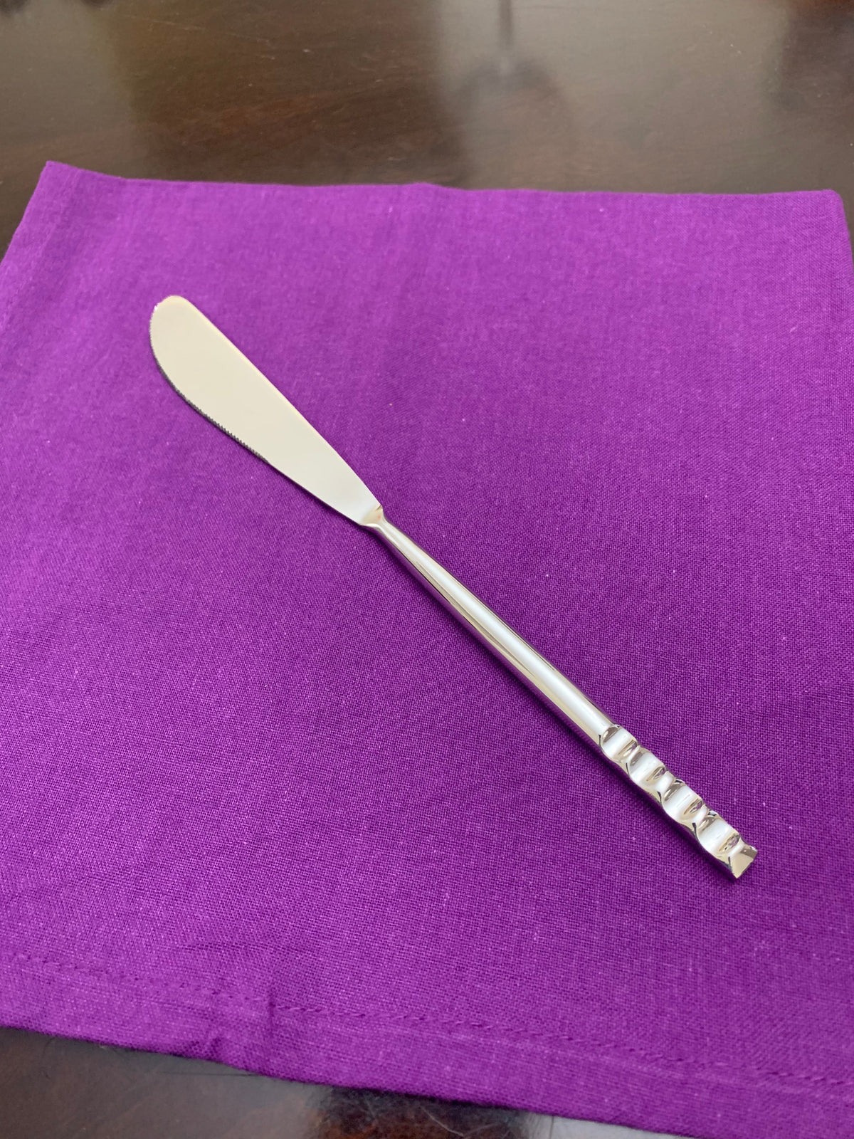 Butter knife from modern flatware set in stainless steel with a decorative ribbed handle on Tampa Home & Garden Store