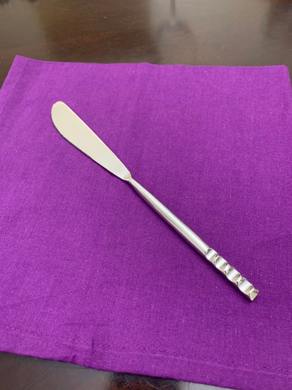 Vibhsa stainless steel knife from modern flatware set on purple napkin on Tampa Home & Garden Store