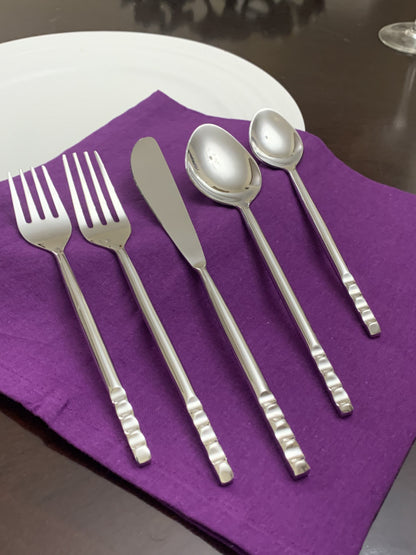 Vibhsa stainless steel 5-piece flatware place setting for 1 on purple napkin on Tampa Home & Garden Store