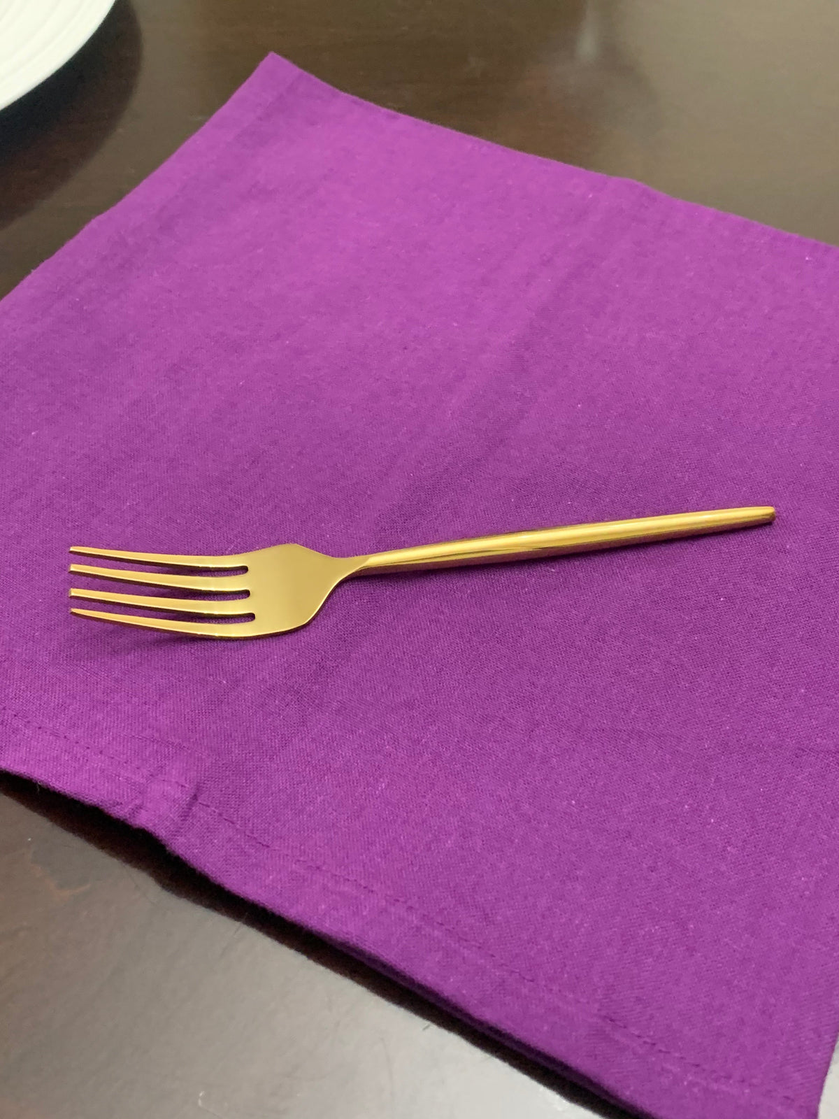 Vibhsa gold flatware fork on purple napkin from 20-piece set for 4 on Tampa Home & Garden Store