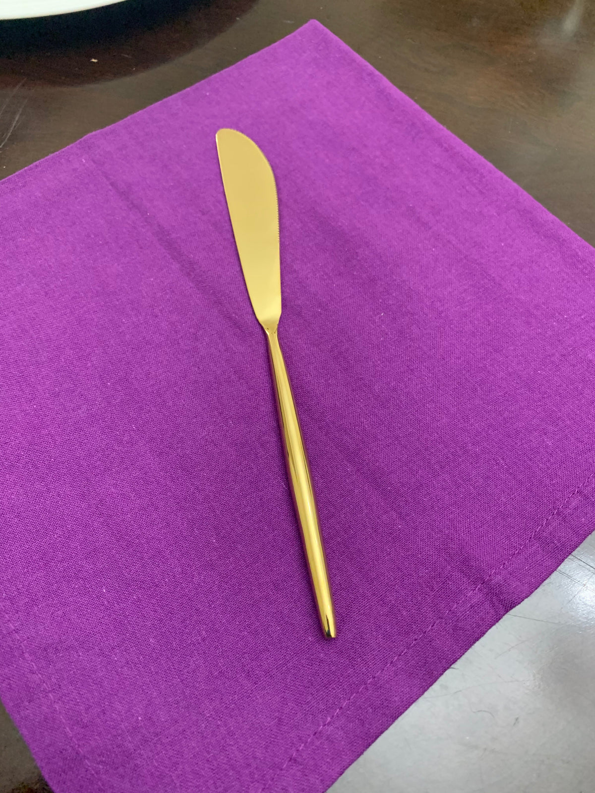 Vibhsa gold flatware knife on purple napkin close up on Tampa Home & Garden Store
