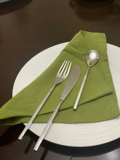 Vibhsa 18-Piece flatware set dinner knife, fork, dessert spoon on green napkin atop white plate on Tampa Home & Garden Store