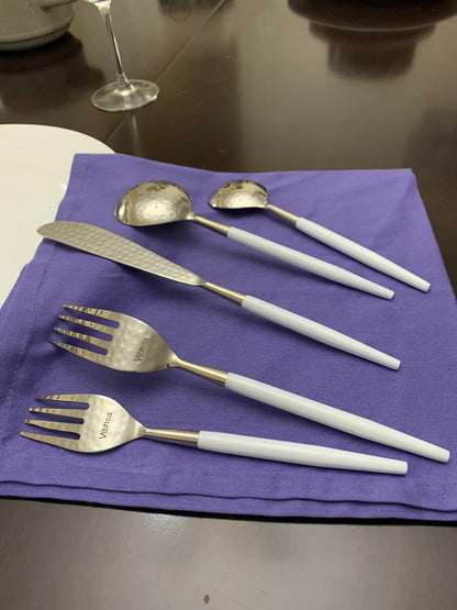 Vibhsa white & silver flatware with hammered spoon bowls and white handles on purple napkin on Tampa Home & Garden Store