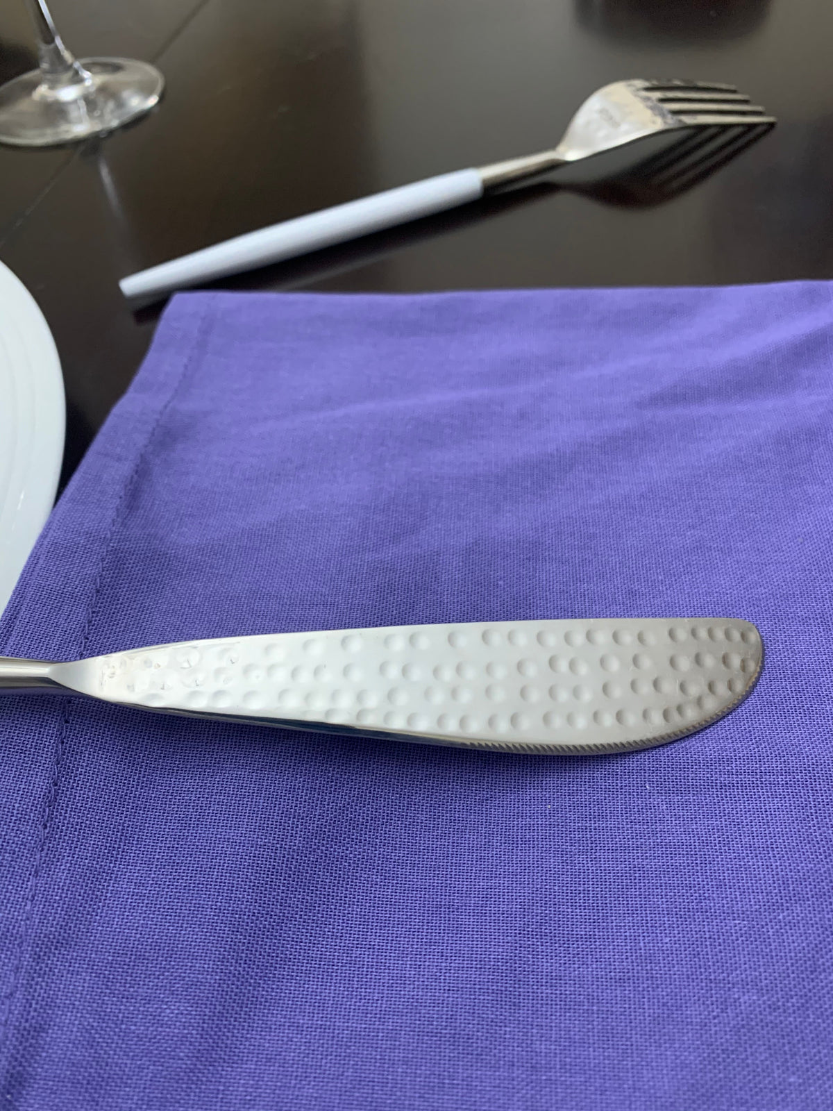 Vibhsa white and silver flatware set of 20 with textured handles on purple napkin on Tampa Home & Garden Store