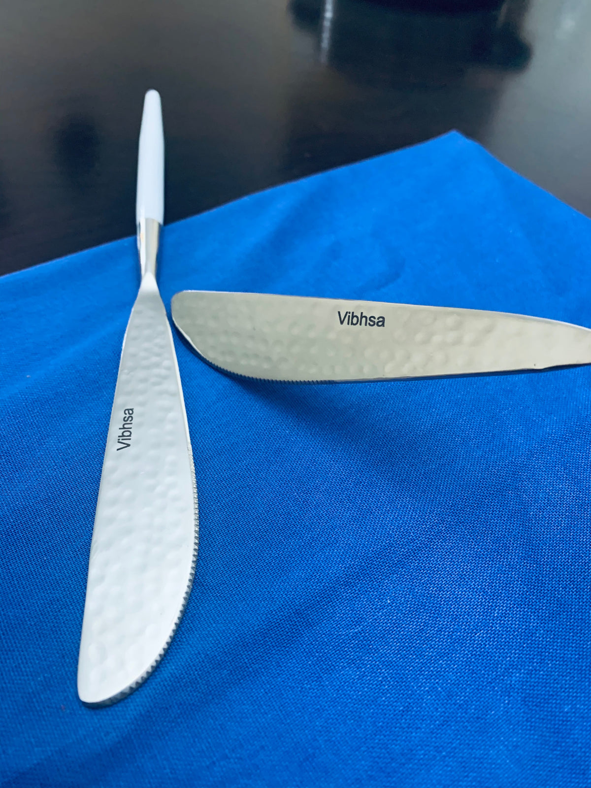2-piece Vibhsa flatware knife and fork with white textured handles, stainless steel on blue on Tampa Home & Garden Store