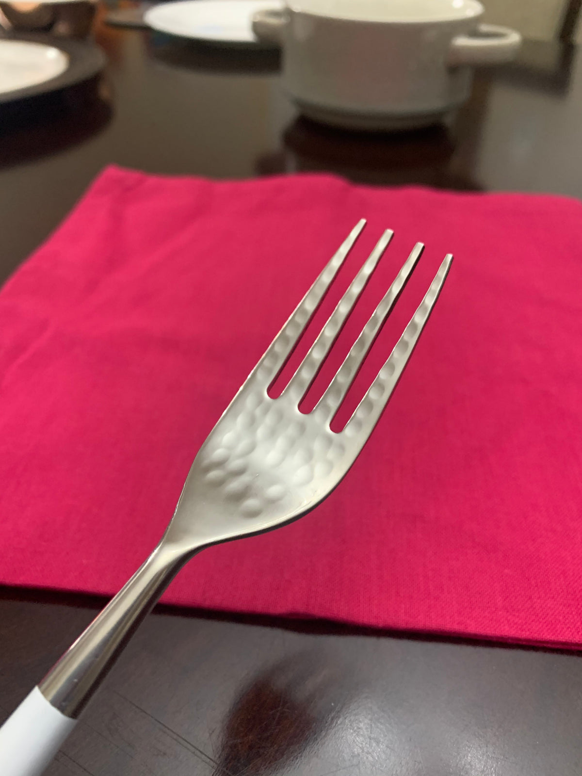 Vibhsa white and silver stainless steel flatware set of 20 forks on pink placemat on Tampa Home & Garden Store