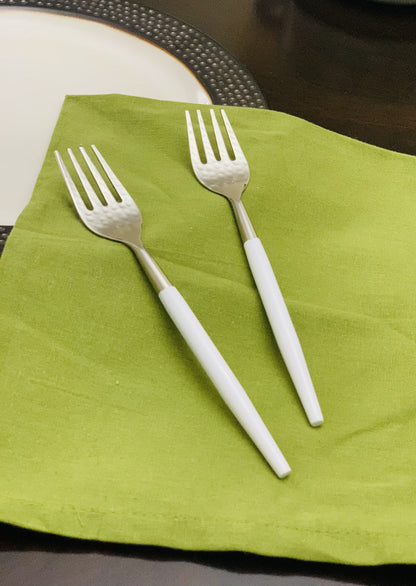 Vibhsa 6-pc stainless steel dinner forks with hammered mouth and white handles on a lime napkin on Tampa Home & Garden Store