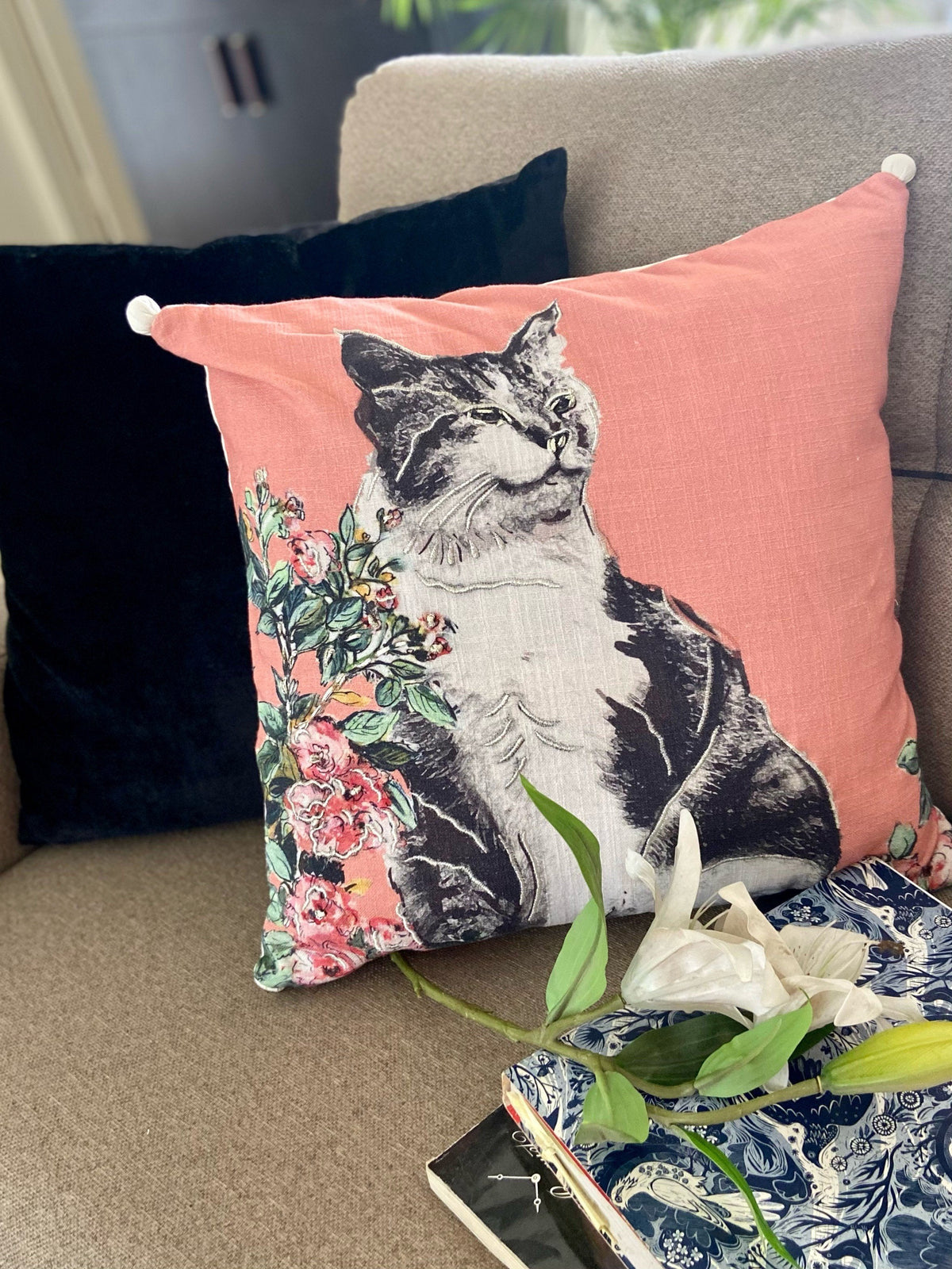 Vibhsa pink decorative pillow 18x18 with cat floral print and white corner tassels on peach fabric on Tampa Home & Garden Store