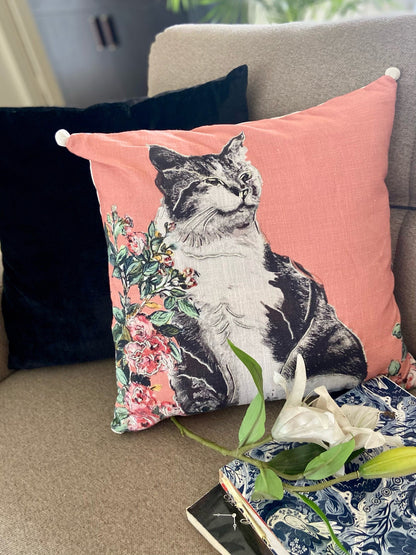 Vibhsa pink decorative pillow 18x18 with cat floral print and white corner tassels on peach fabric on Tampa Home & Garden Store